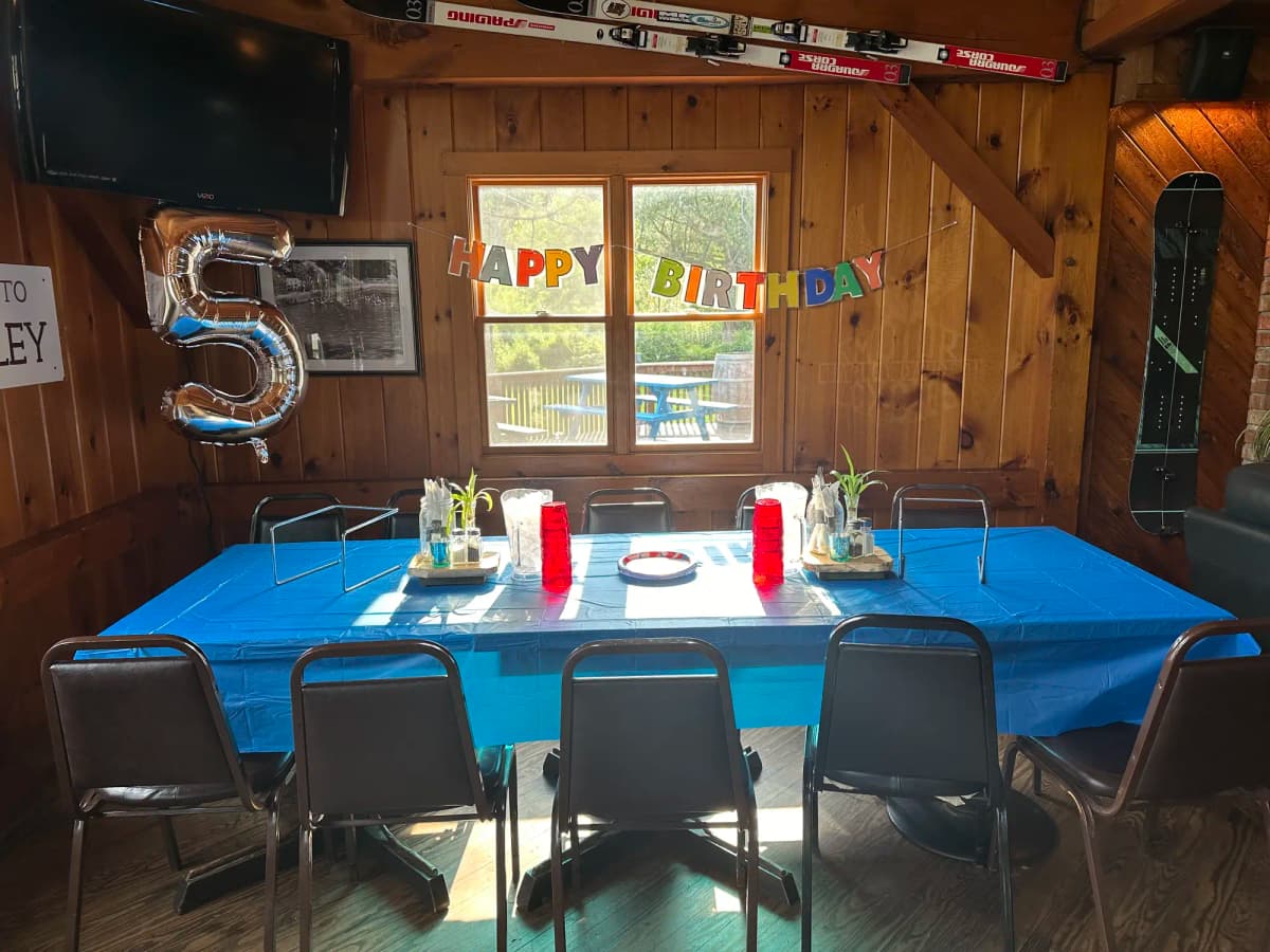 Birthday party setup with blue tablecloth and festive decorations