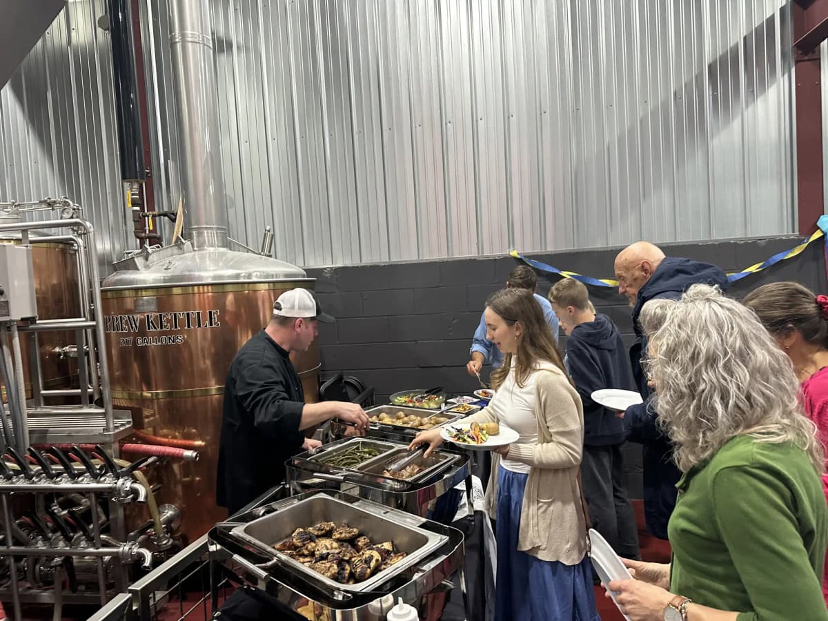 Guests enjoying catering buffet at brewery event