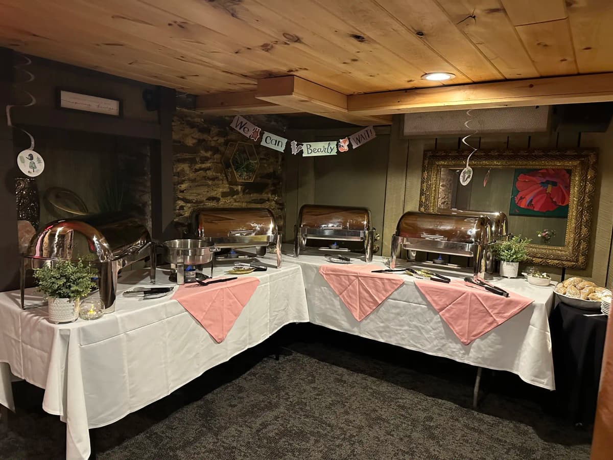 Elegant buffet station with multiple chafing dishes and pink accents