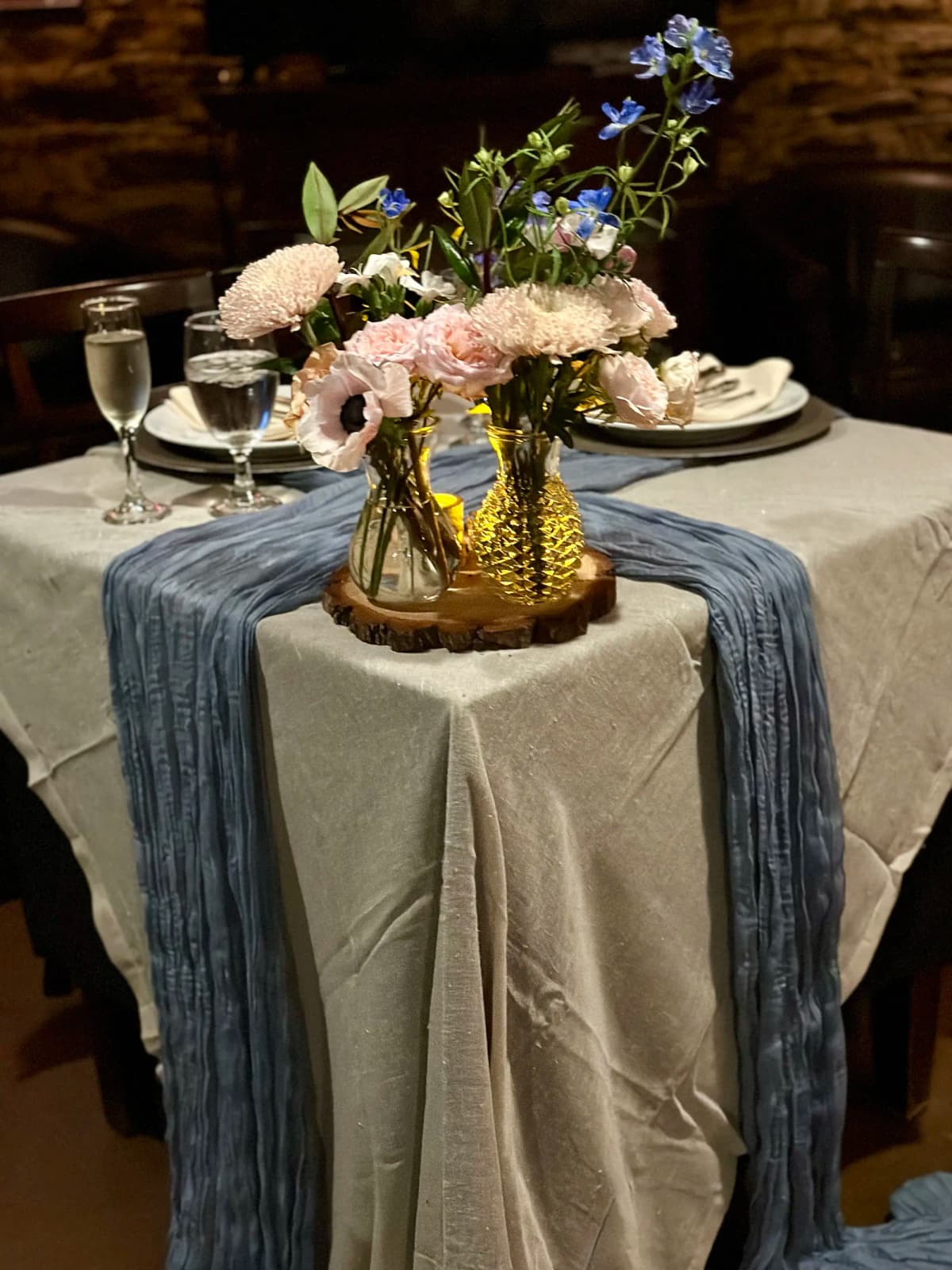Elegant table with blue and pink floral centerpiece in glass vases
