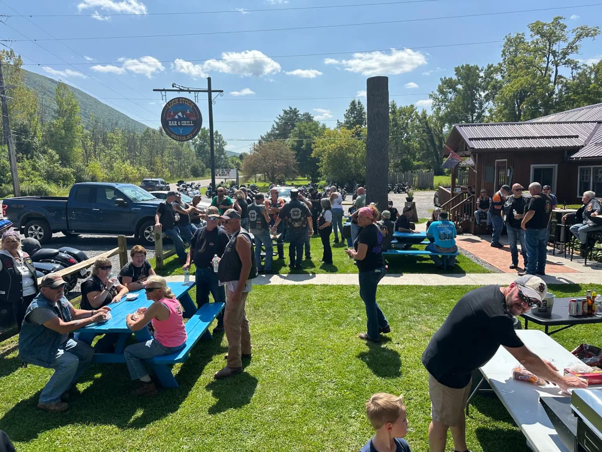 Outdoor event with guests gathered on lawn