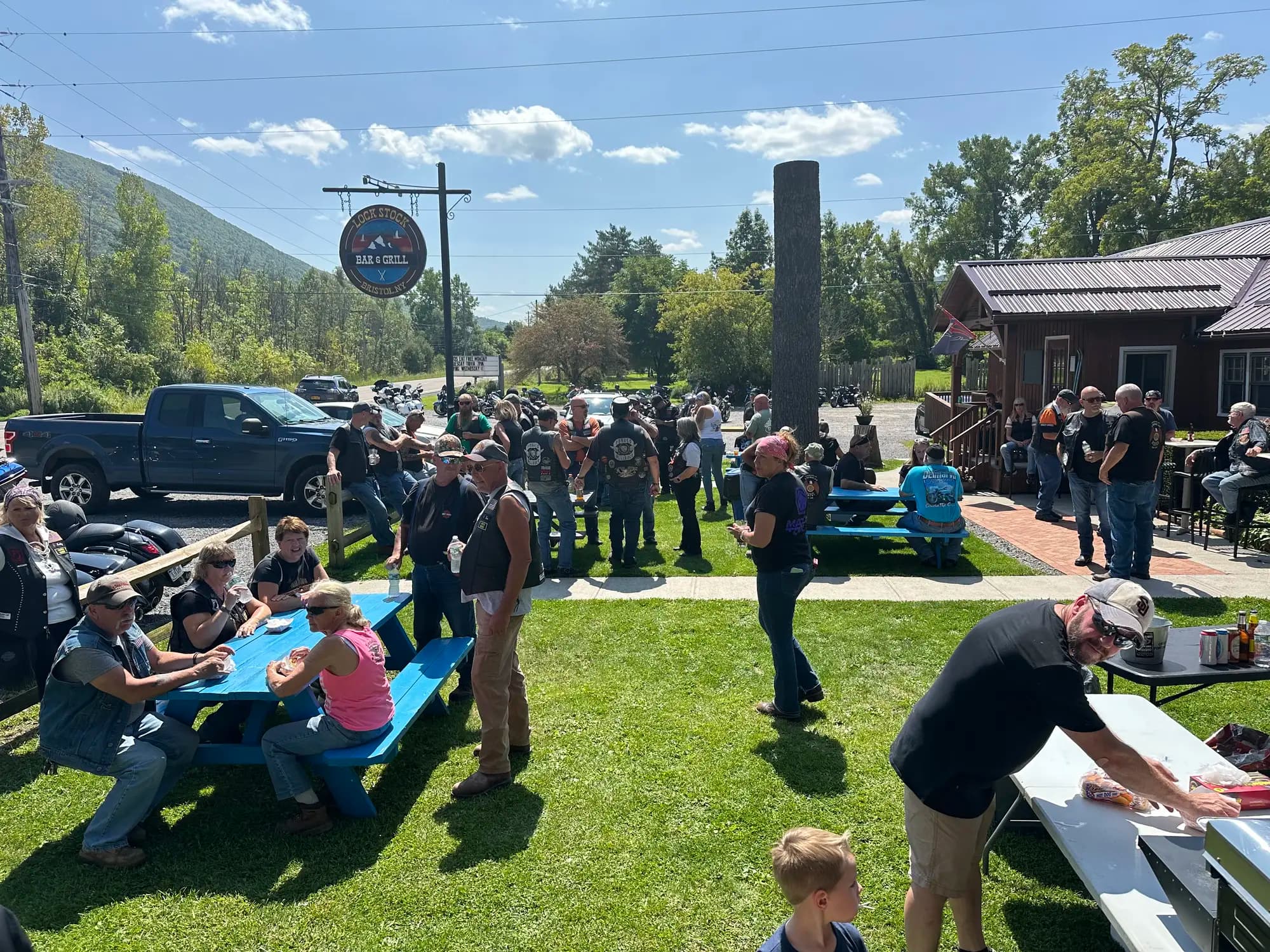 Outdoor event with guests gathered on lawn