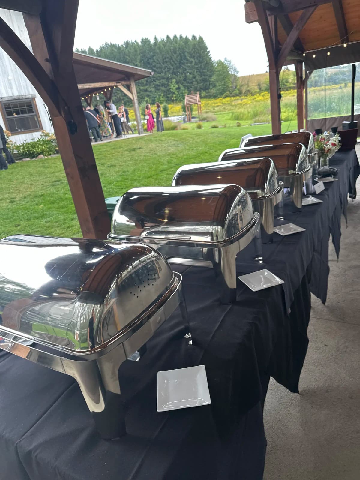 Outdoor pavilion setup with black chair covers