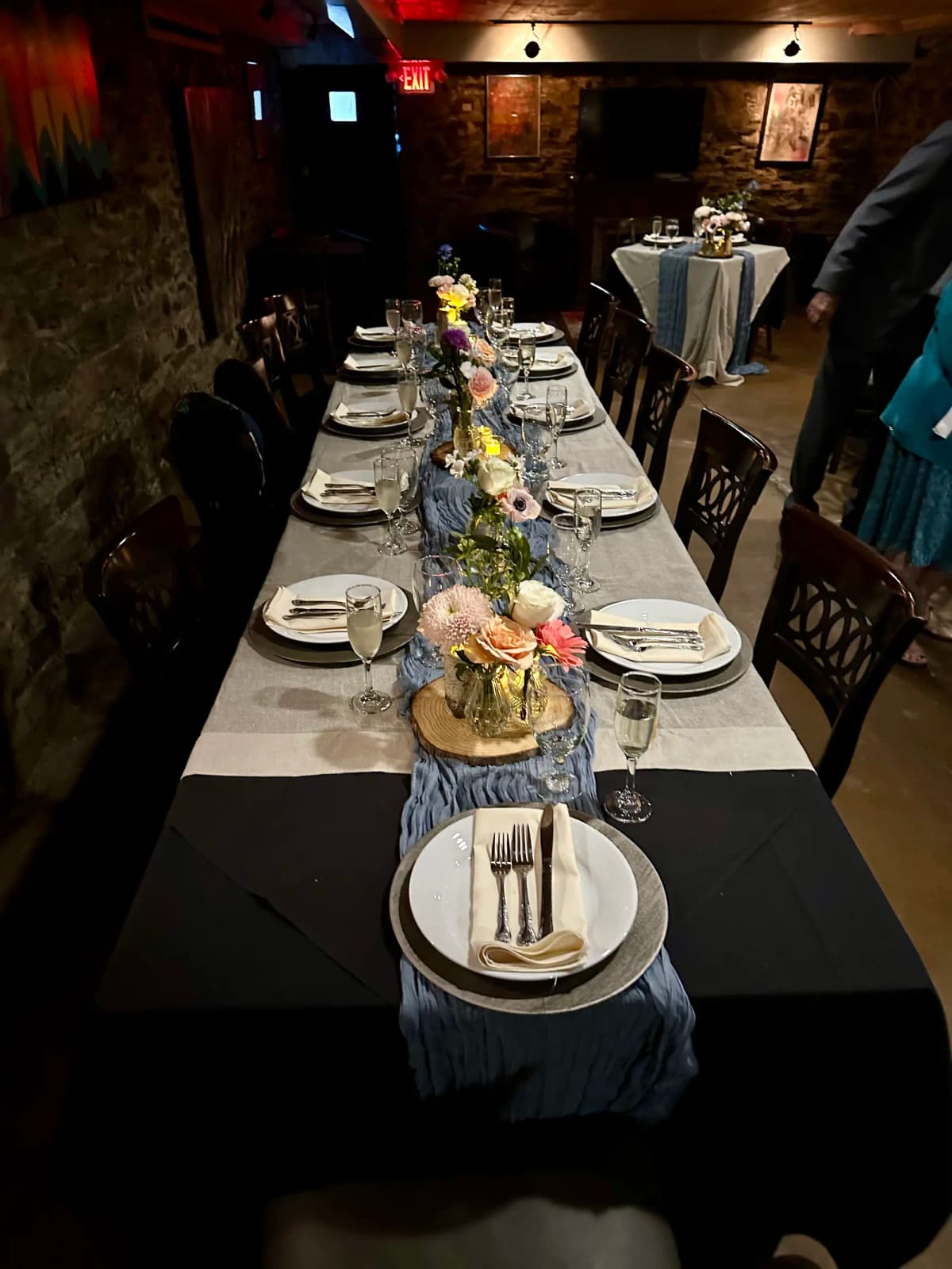 Private dining room with formal table setting and floral arrangements