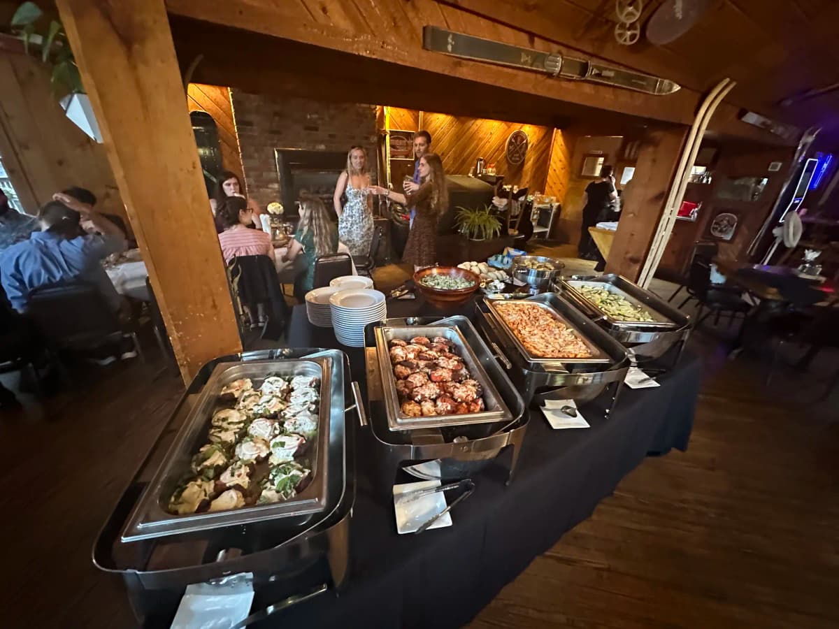 Restaurant buffet with variety of hot dishes in chafing pans