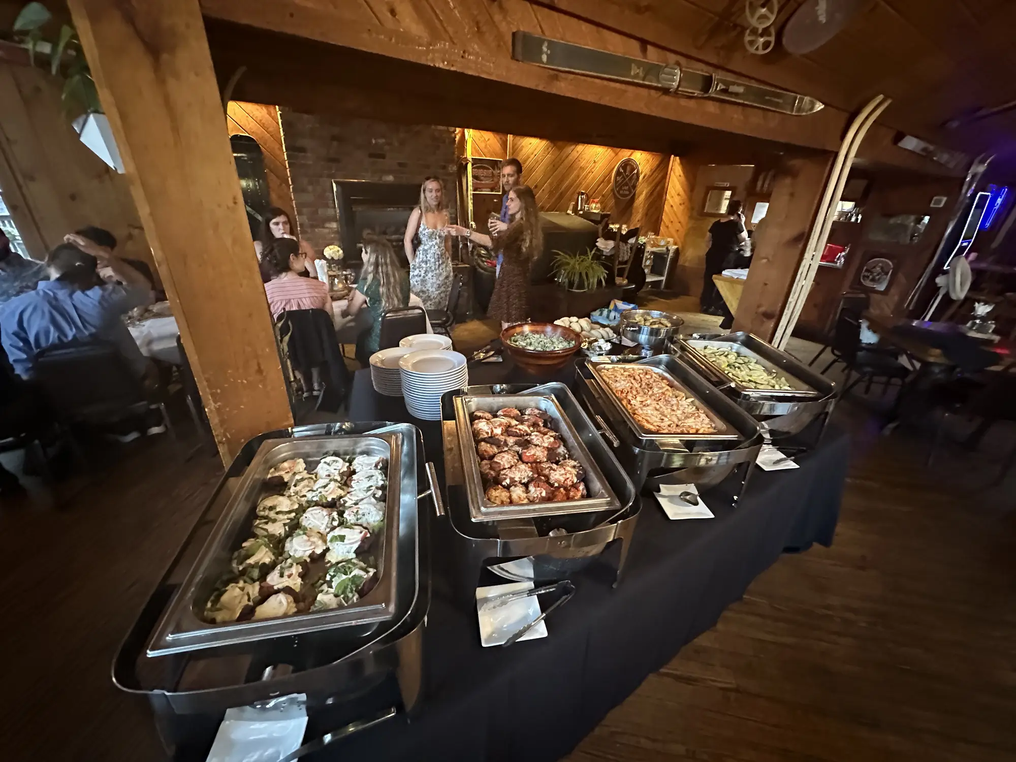 Restaurant buffet with variety of hot dishes in chafing pans