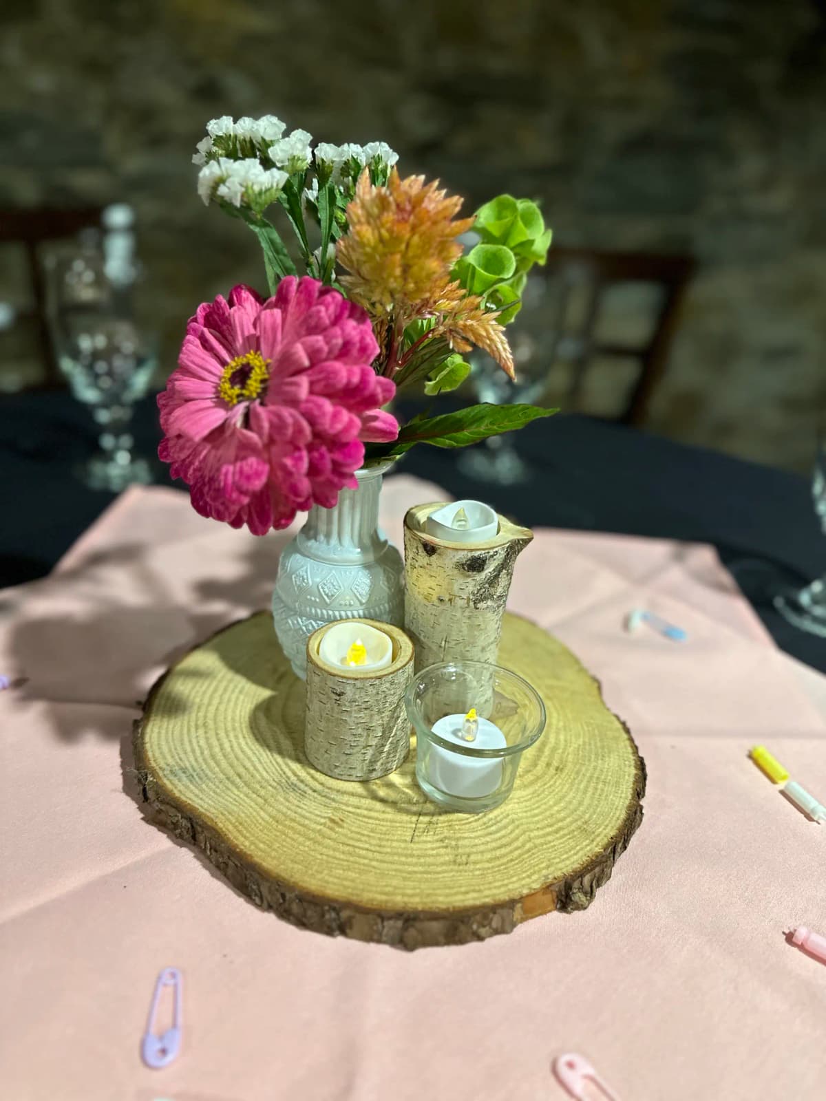 Rustic floral centerpiece with colorful flowers and candles