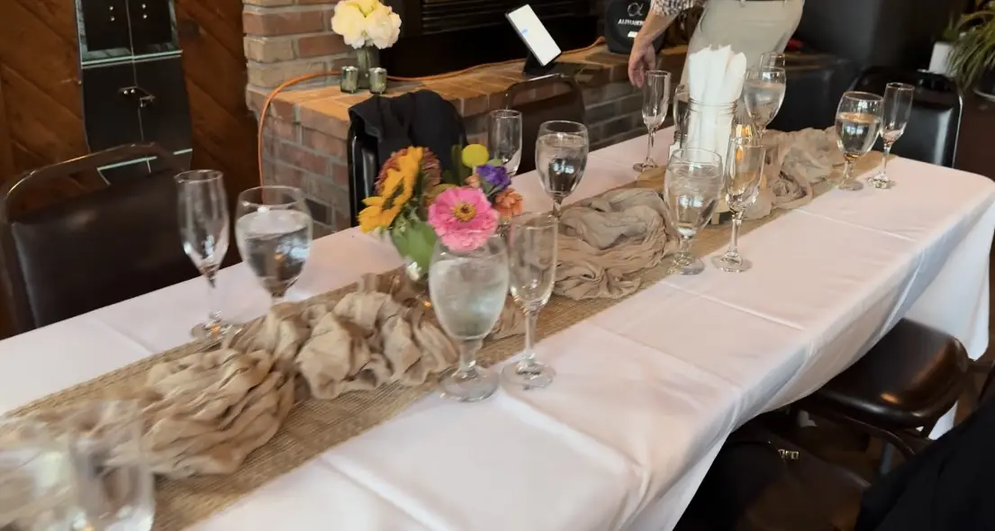 Rustic table setting with burlap runner and complete glassware