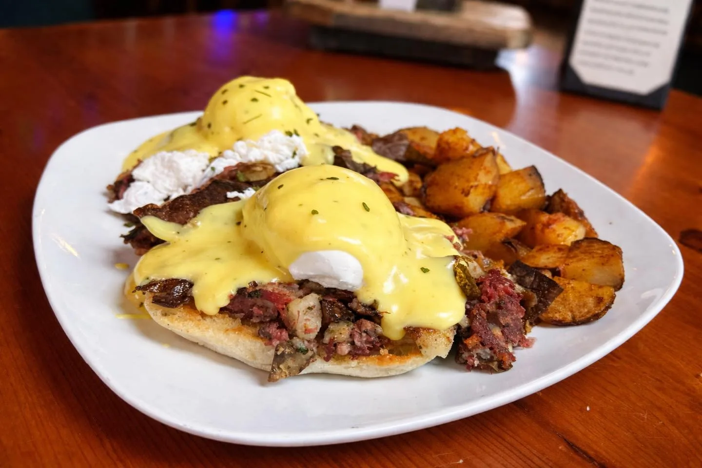 Irish Benedict with pastrami hash, poached eggs, hollandaise and home fries
